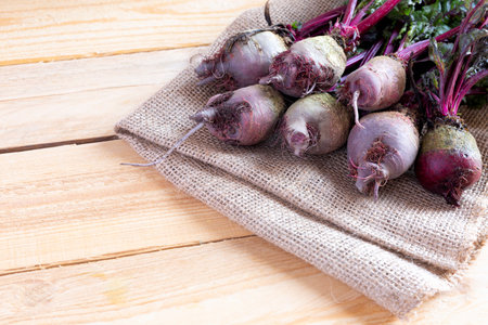 Fresh beetroot harvest in the garden. Bunch of freshly picked raw beetroot on wooden background....