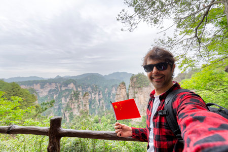 Young tourist enjoying mountain view, the Zhangjiajie National Forest Park, Hunan Province, Chinaの写真素材