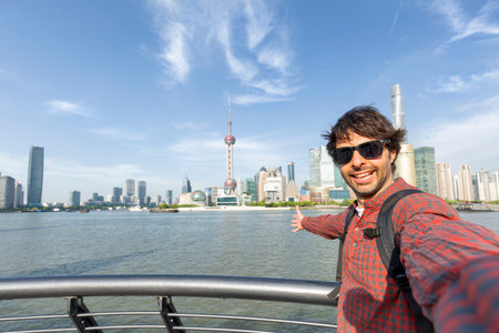 man traveler visiting in Shanghai, China. male Tourist sightseeing Shanghai view of Lujiazui in The...