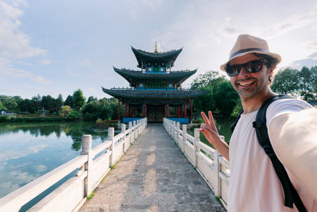 A boy takes a selfie in a Chinese-style temple.の写真素材