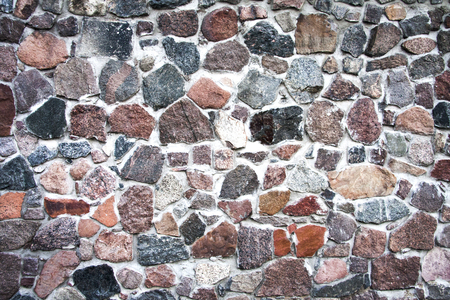 Background of stone wall texture photo. old path paved with cobblestones colorfulの写真素材