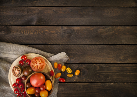 colorful tomatoes on a wooden table. top viewの写真素材