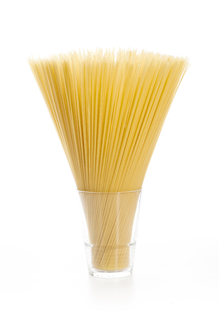 Uncooked pasta spaghetti on white backgroundの写真素材