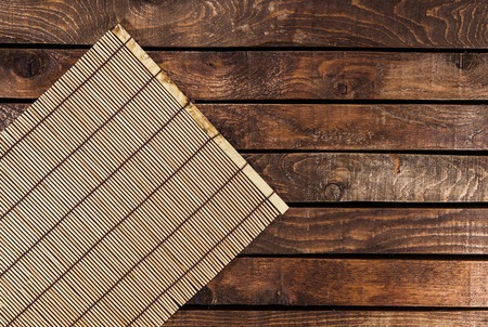 Bamboo tablecloth on wooden table over grunge background. Ready for product display montageの写真素材