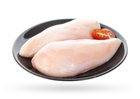 raw chicken fillets on a plate isolated on white backgroundの写真素材