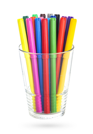 Group of color felt-tipped pens in a glass, white background, isolatedの写真素材