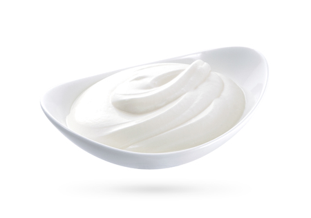 sour cream in bowl, isolated on whiteの写真素材