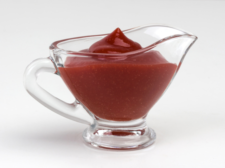 tomato sauce in glass bowl isolated on white background. With clipping path.の写真素材