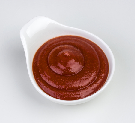 Bowl of ketchup or tomato sauce isolated on white background. With clipping path.の写真素材