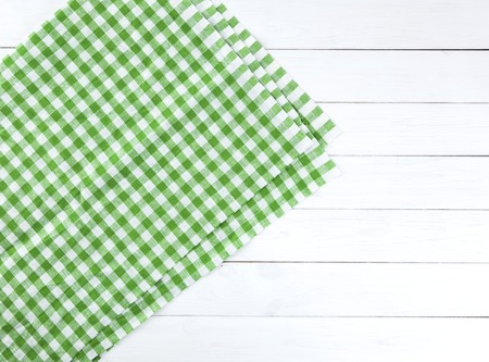 Green towel over wooden kitchen table. View from aboveの写真素材