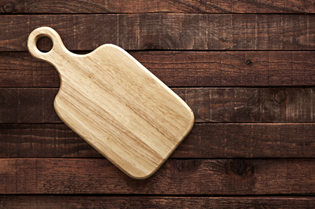cutting board on a dark wooden table. top viewの写真素材