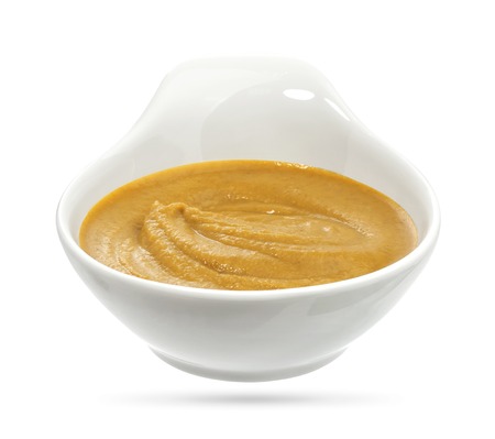Bowl of mustard on white background.の写真素材