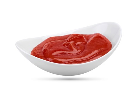 Ketchup in bowl isolated on white background. Portion of tomato sauce. With clipping path.の写真素材