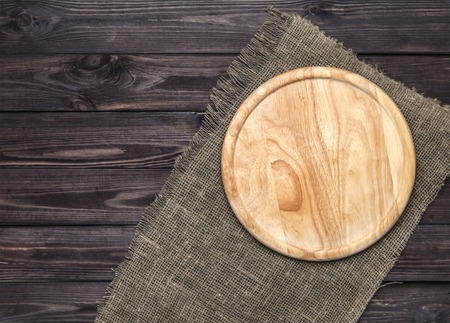 Cutting board on a wooden table, top viewの写真素材