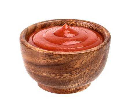 Wood bowl of ketchup isolated on white background. With clipping path.の写真素材