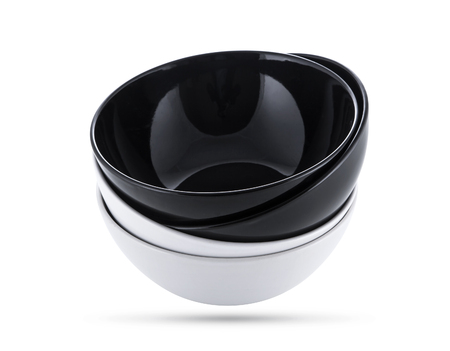 A stack of black and white bowls isolated, black and white imageの写真素材