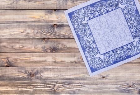 Blue cloth on a wooden table, top view, Natural linen napkin