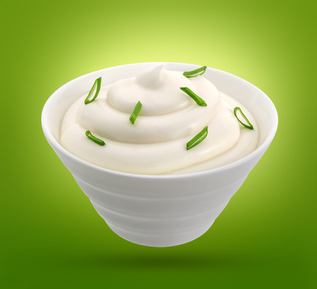 Sour cream with onion in a bowl isolated on white background, with clipping path.の写真素材