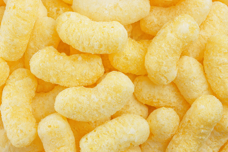 Sweet crunchy corn sticks or snacks backgroundの写真素材