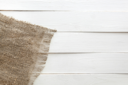 Burlap texture on white wooden table background. Wooden table with sackingの写真素材