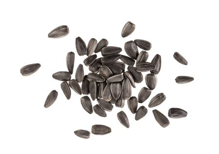 Heap of black sunflower seeds isolated on white background with clipping pathの写真素材