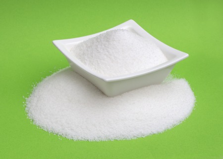 Sugar in a bowl isolated on white background, top viewの写真素材