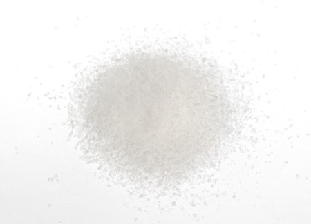 Close-up of pile of sugar isolated on a yellow backgroundの写真素材