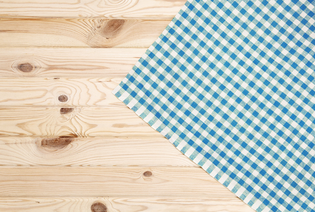 Blue checkered towel over wooden kitchen table. View from aboveの写真素材