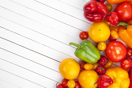 Tomatoes on white wooden background, top viewの写真素材