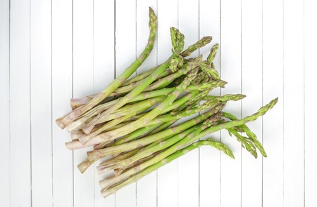 Fresh green asparagus on a white wooden background. top viewの写真素材