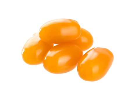 Heap of orange cherry tomatoes isolated on white backgroundの写真素材