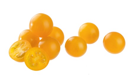 Heap of orange cherry tomatoes isolated on white backgroundの写真素材