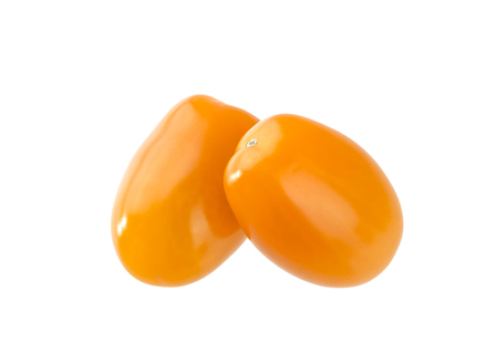 Heap of orange cherry tomatoes isolated on white backgroundの写真素材