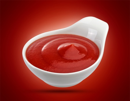 Ketchup in bowl isolated on white background. Portion of tomato sauce. With clipping path.の写真素材