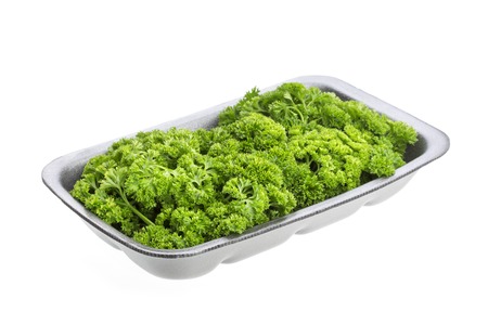 Parsley in plastic wrap packaging isolated on white backgroundの写真素材