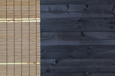 Bamboo mat on dark wooden table, top viewの写真素材