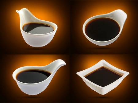Bowl with soy sauce isolated on black backgroundの写真素材