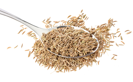 Cumin seeds or caraway in spoon isolated on white background, top viewの写真素材