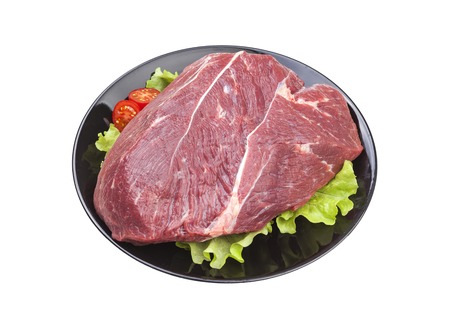 Fresh piece of raw beef on plate isolated on white background.の写真素材