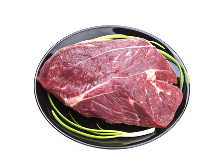 Fresh piece of raw beef on plate isolated on white background.の写真素材