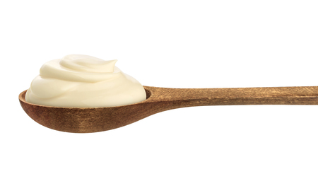 Sour cream in wooden spoon isolated on white background with clipping pathの写真素材