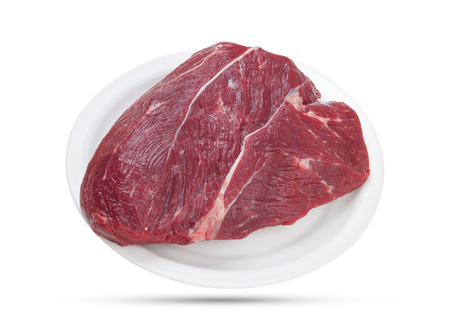Fresh piece of raw beef on plate isolated on white background.の写真素材