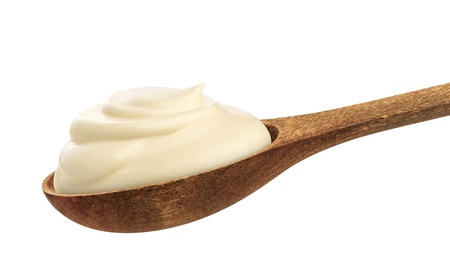 Sour cream in wooden spoon isolated on white background with clipping pathの写真素材