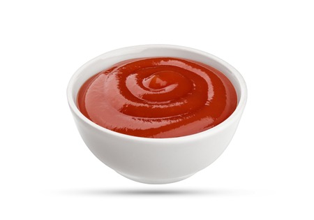 Ketchup in bowl isolated on white background. Portion of red tomato sauce. With clipping path.の写真素材
