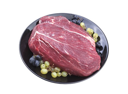 Fresh piece of raw beef on plate isolated on white background.の写真素材
