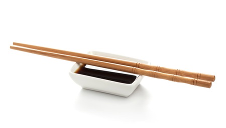 Soy sauce and chopsticks isolated on white background, with clipping pathの写真素材
