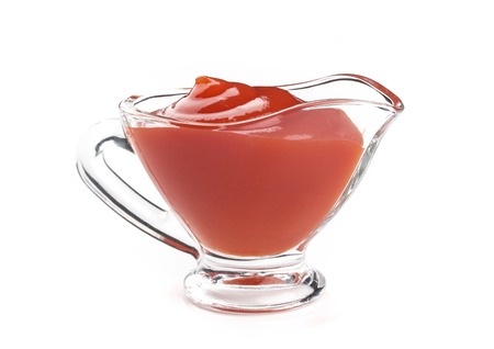 Ketchup in glass bowl isolated on white background. Portion of tomato sauce. With clipping path.の写真素材