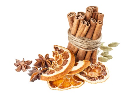 Dried orange, anise stars and cinnamon sticks isolated on white backgroundの写真素材