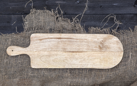 Empty chopping board on wooden table, cheese background concept, top viewの写真素材