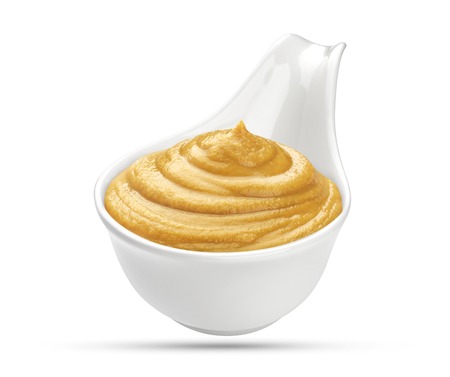 Mustard in bowl isolated on white backgroundの写真素材